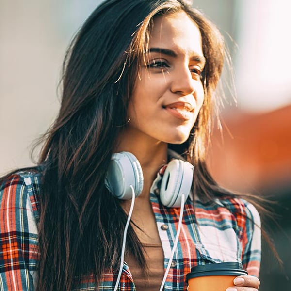 Photo of a woman with headphones around her neck