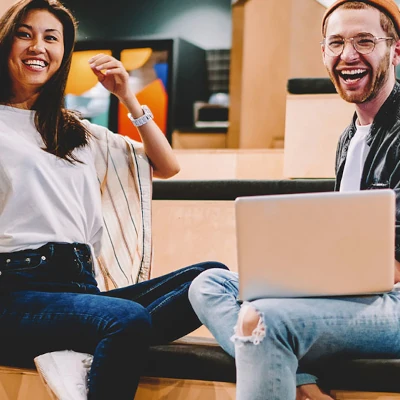 Woman and man sitting and smiling at the camera