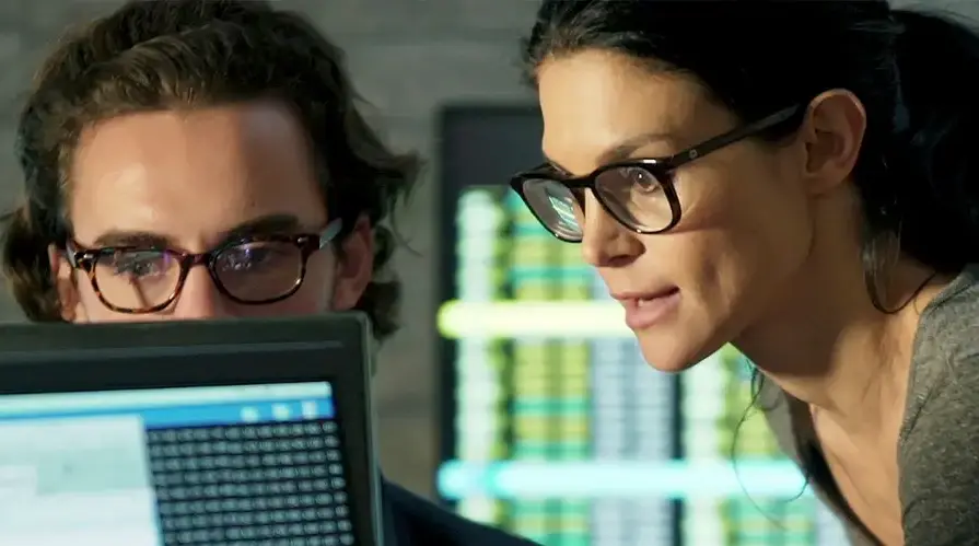 Man and woman looking at laptop