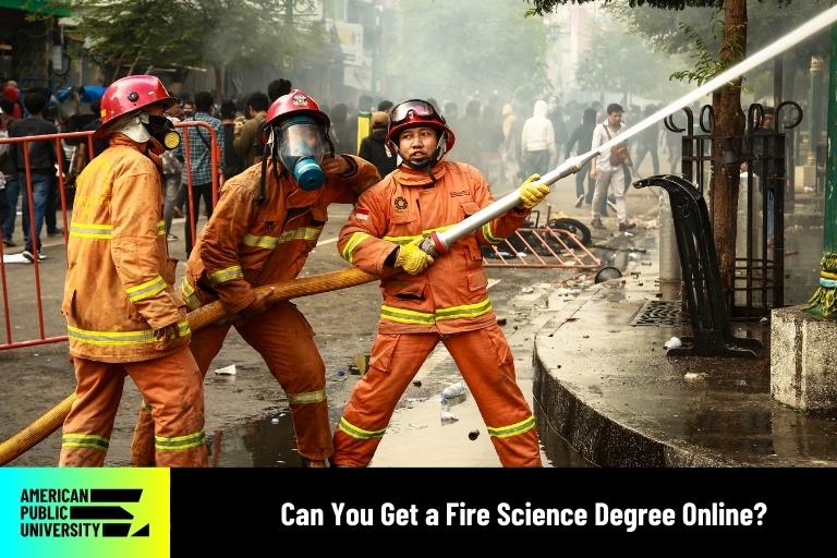 can-you-get-a-fire-science-degree-online fire science students practicing with fire hose