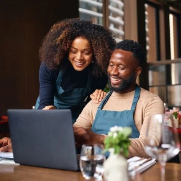 Two people looking at a laptop