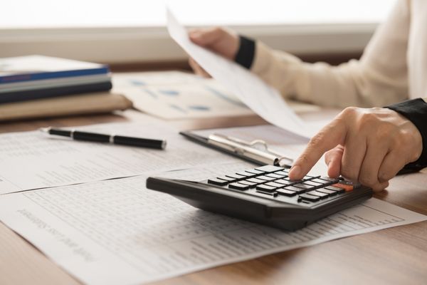accountant working on calculator