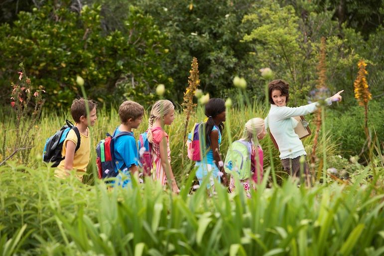 humane education practicing teacher with students in nature