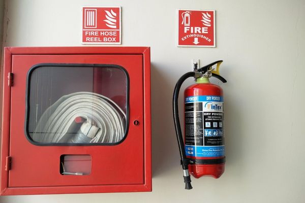 fire hose and extinguisher on wall