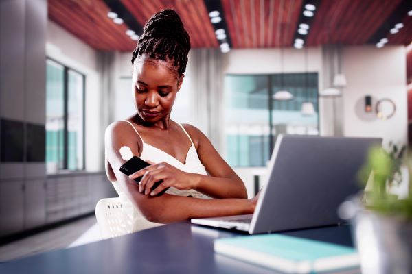 female scanning diabetic arm monitor with phone