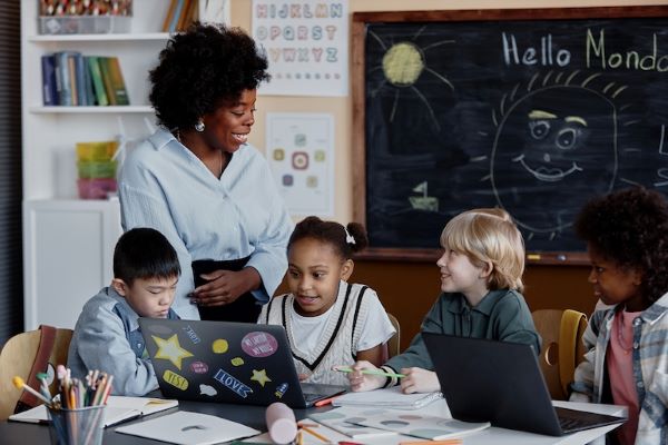 teacher discussing cyber safety with students