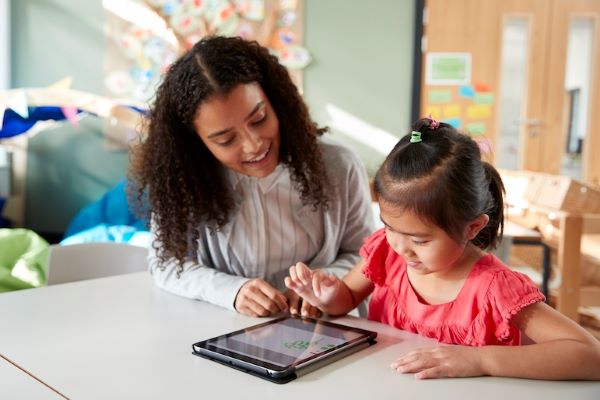 technology being used on tablet by teacher and student