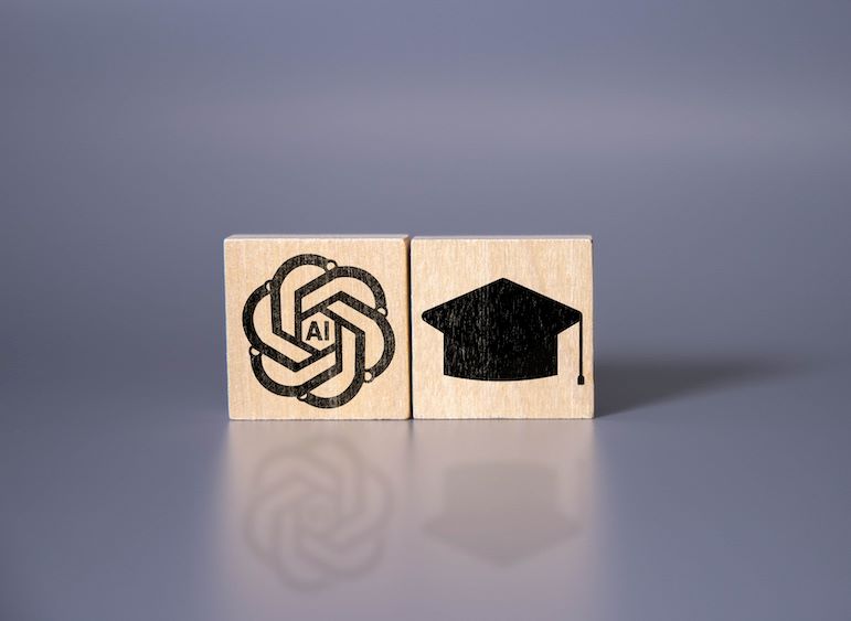 AI icon and graduation cap on wooden blocks