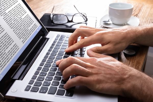 English degree student typing on laptop