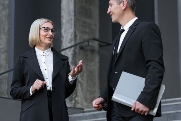 international relations professionals talking on courthouse steps