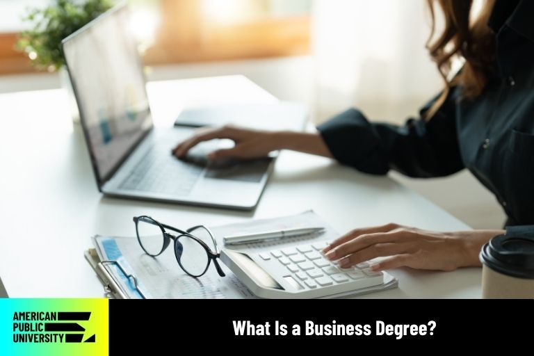 what-is-a-business-degree business professional typing on calculator