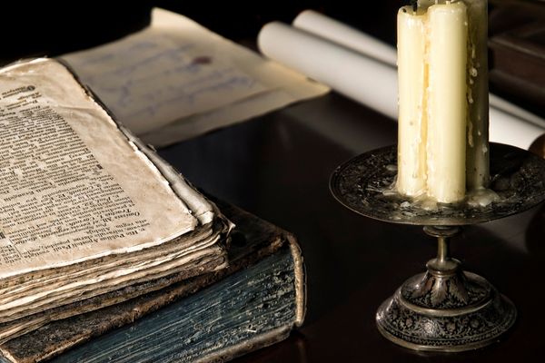 religious book next to wax candle