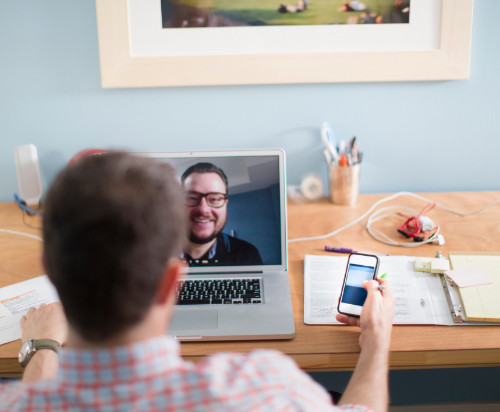 Someone using the computer and video calling a peer