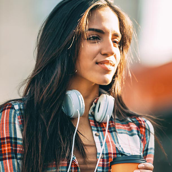 Photo of a woman with headphones around her neck