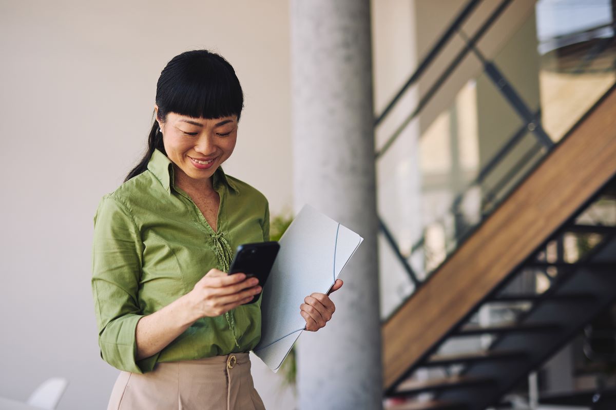 woman smiling looking at phone