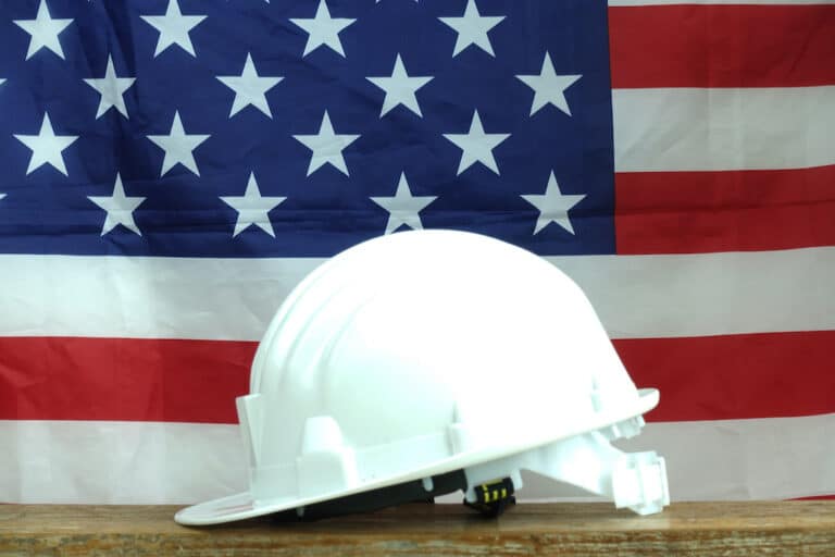 hard hat in front of flag